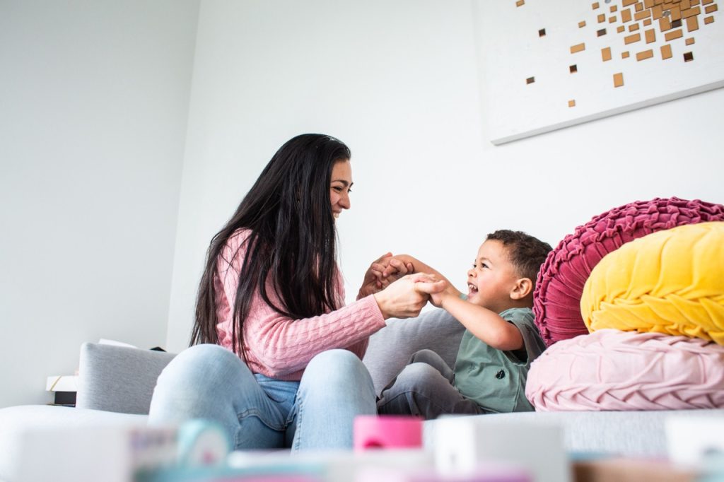 een au pair spelend met een kind