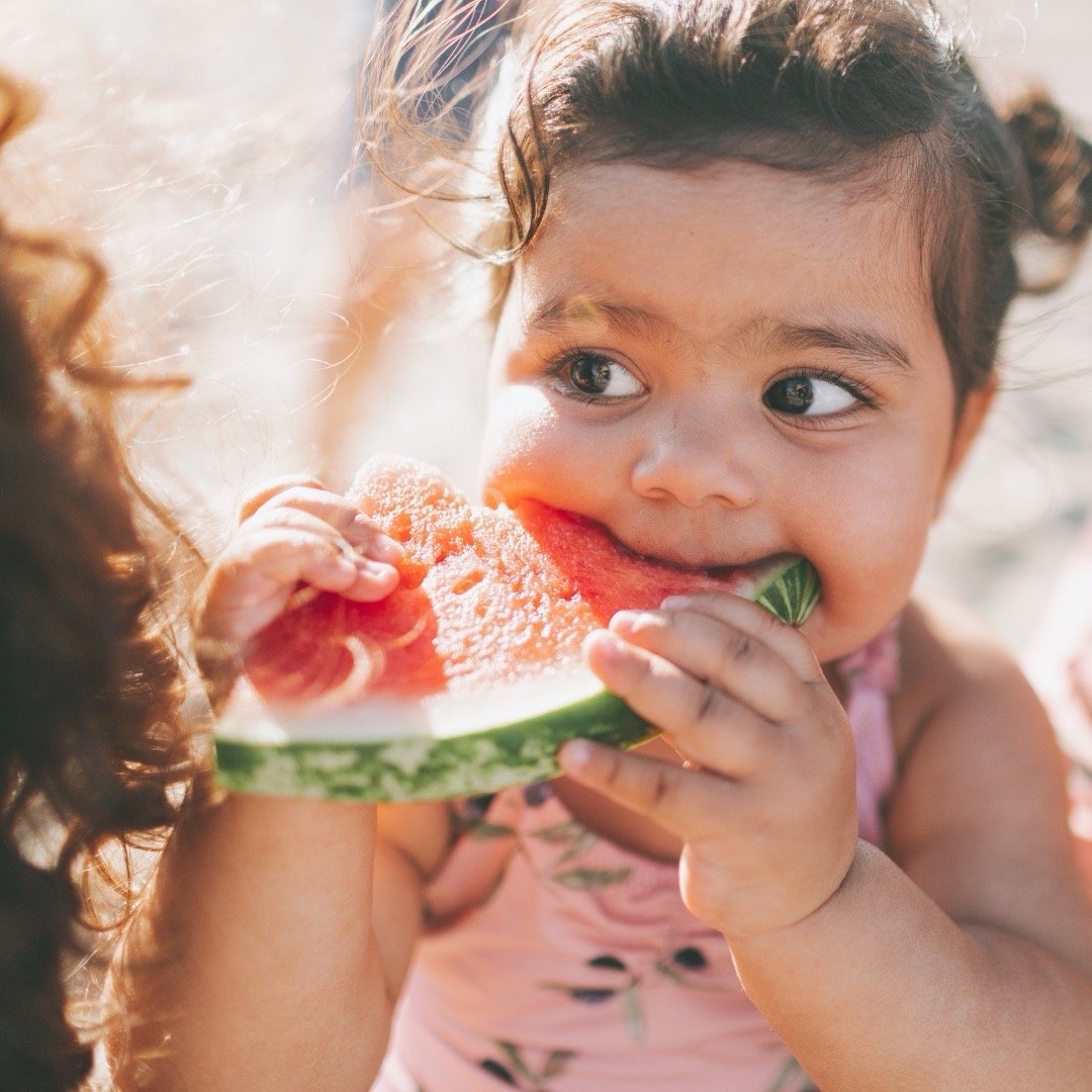 a kid eating a watermelon