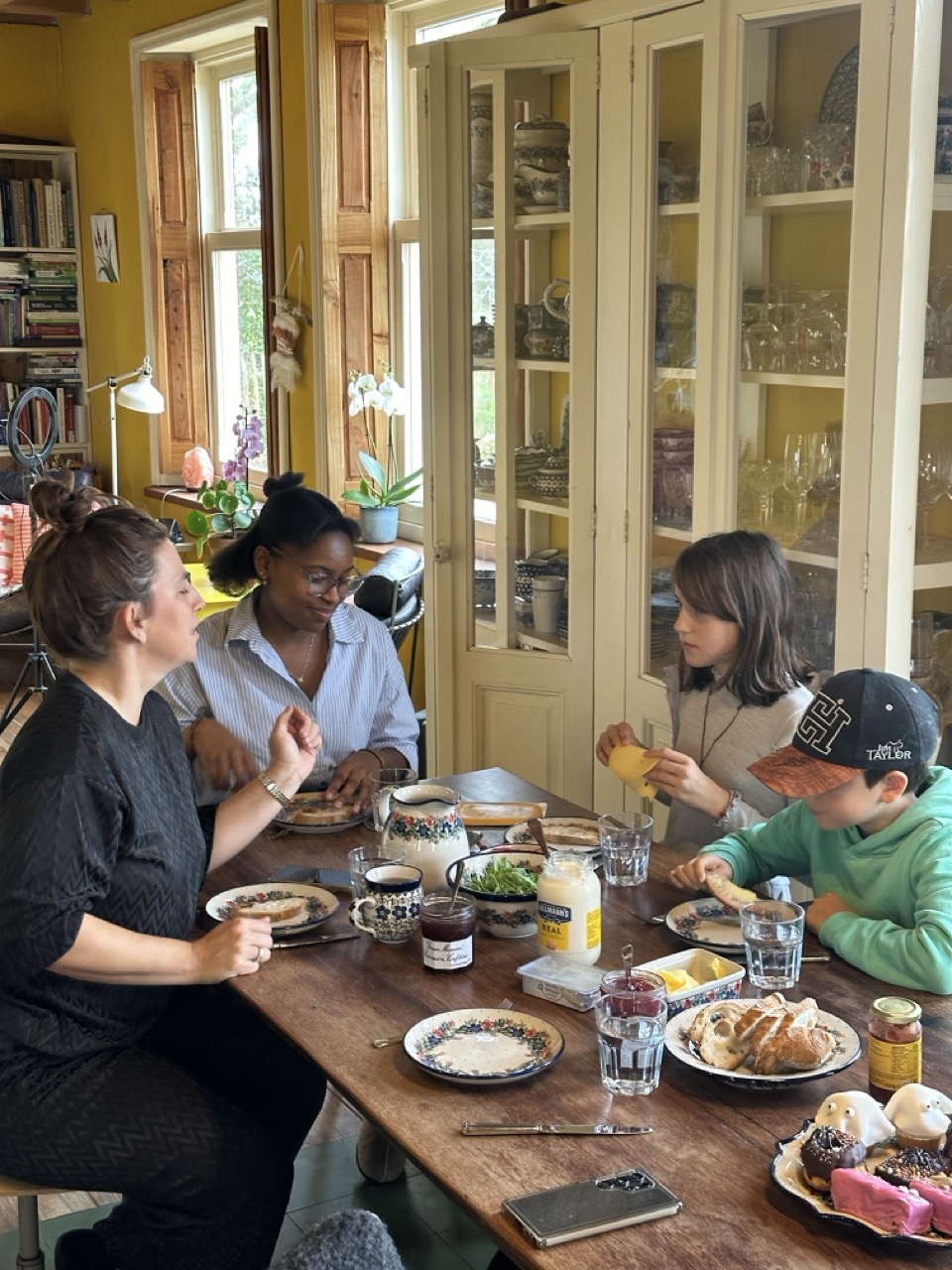 esther and the family eating at the dinner table